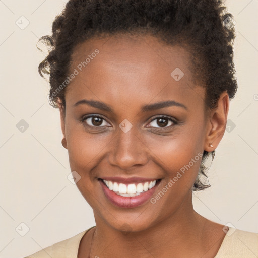 Joyful black young-adult female with short  brown hair and brown eyes