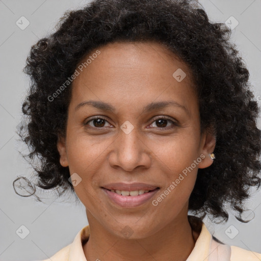 Joyful black adult female with medium  brown hair and brown eyes