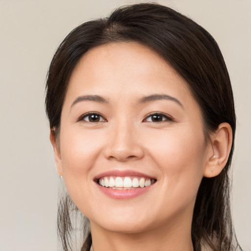 Joyful white young-adult female with medium  brown hair and brown eyes