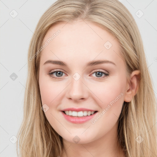 Joyful white young-adult female with long  brown hair and blue eyes