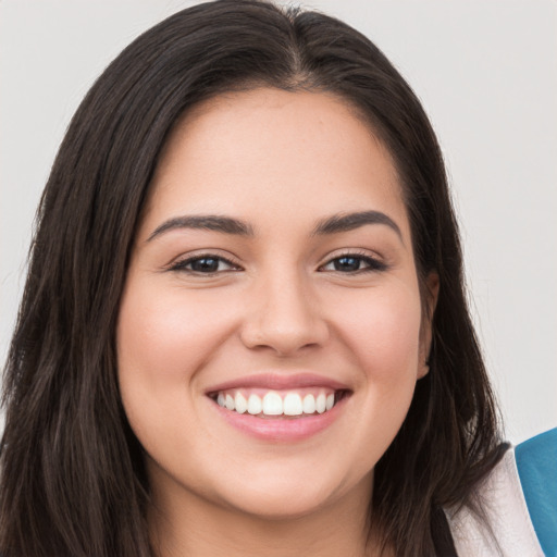 Joyful white young-adult female with long  brown hair and brown eyes