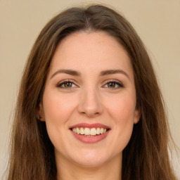 Joyful white young-adult female with long  brown hair and green eyes