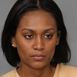 Neutral black young-adult female with medium  brown hair and brown eyes