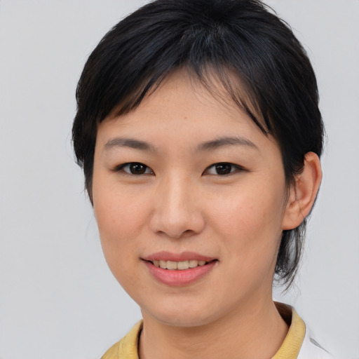 Joyful asian young-adult female with medium  brown hair and brown eyes