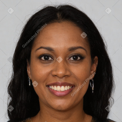 Joyful black young-adult female with long  brown hair and brown eyes