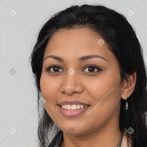 Joyful latino young-adult female with long  brown hair and brown eyes