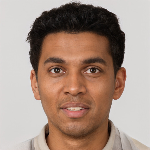 Joyful latino young-adult male with short  brown hair and brown eyes