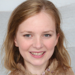 Joyful white young-adult female with medium  brown hair and blue eyes