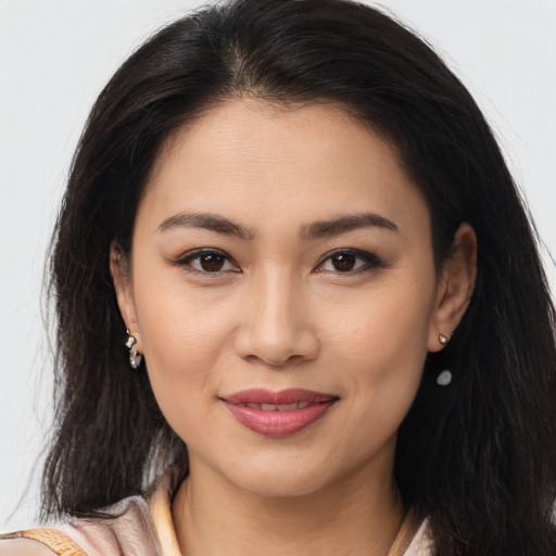 Joyful latino young-adult female with long  brown hair and brown eyes