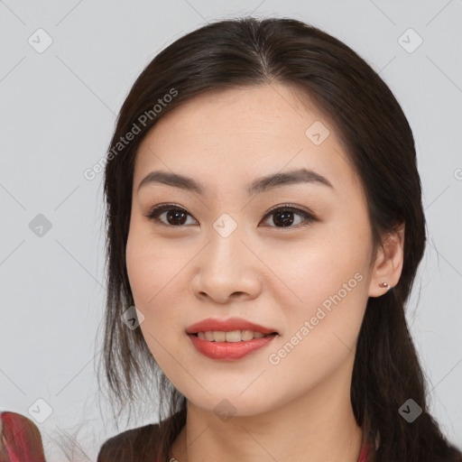 Joyful asian young-adult female with long  brown hair and brown eyes