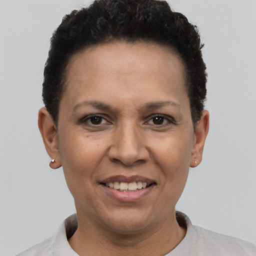 Joyful latino adult female with short  black hair and brown eyes