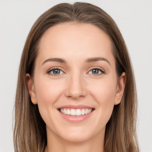 Joyful white young-adult female with long  brown hair and grey eyes