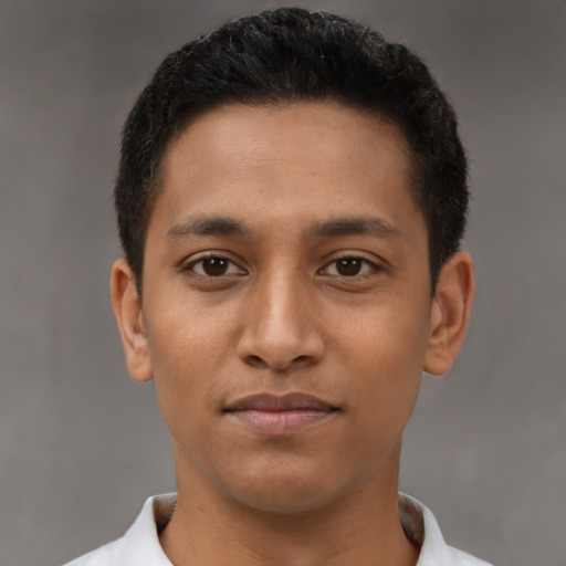 Joyful latino young-adult male with short  brown hair and brown eyes