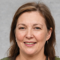 Joyful white adult female with medium  brown hair and grey eyes