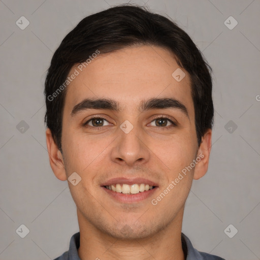 Joyful white young-adult male with short  black hair and brown eyes