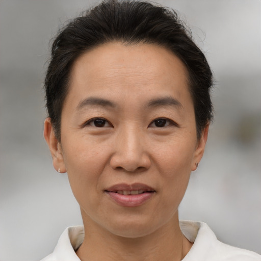 Joyful white adult female with short  brown hair and brown eyes