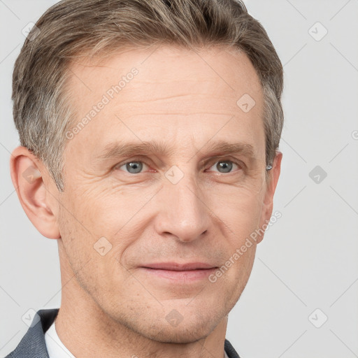 Joyful white adult male with short  brown hair and grey eyes