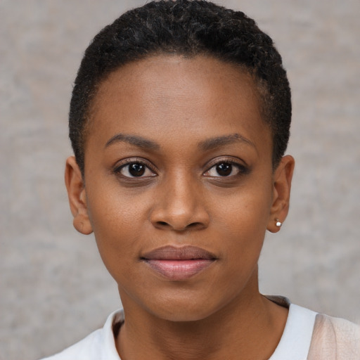 Joyful black young-adult female with short  brown hair and brown eyes
