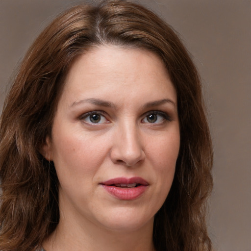 Joyful white young-adult female with long  brown hair and green eyes