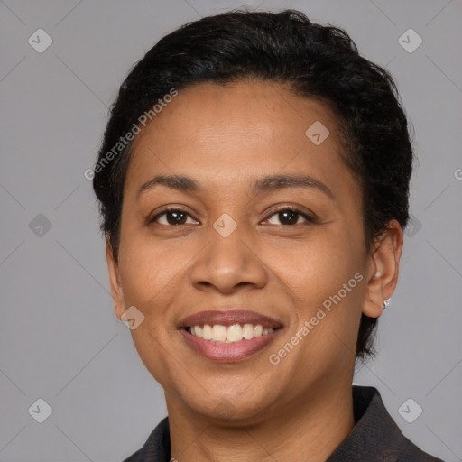 Joyful latino adult female with short  brown hair and brown eyes