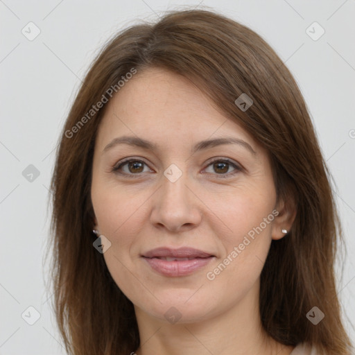 Joyful white adult female with long  brown hair and brown eyes