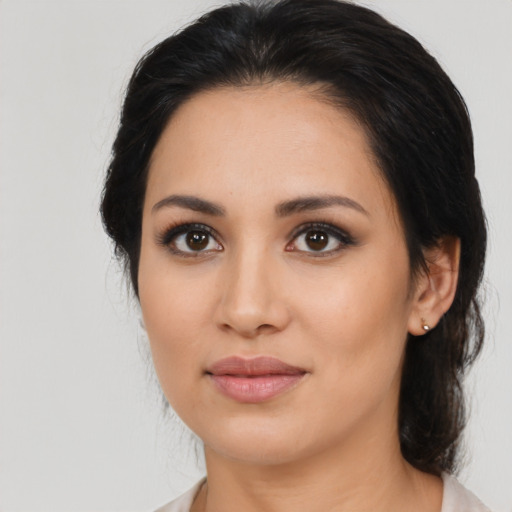 Joyful latino young-adult female with medium  black hair and brown eyes