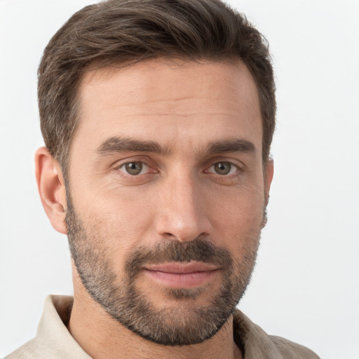 Joyful white young-adult male with short  brown hair and grey eyes