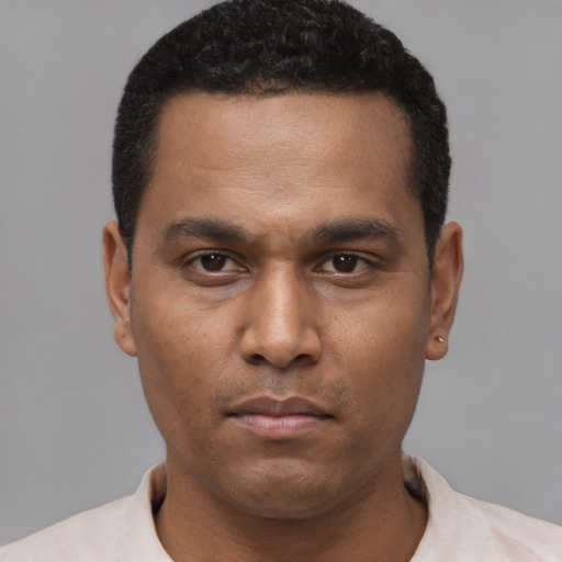 Neutral latino young-adult male with short  black hair and brown eyes