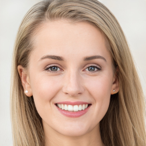 Joyful white young-adult female with long  brown hair and grey eyes