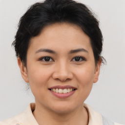 Joyful asian young-adult female with short  brown hair and brown eyes