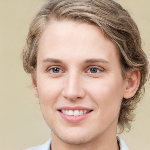 Joyful white young-adult female with medium  brown hair and blue eyes