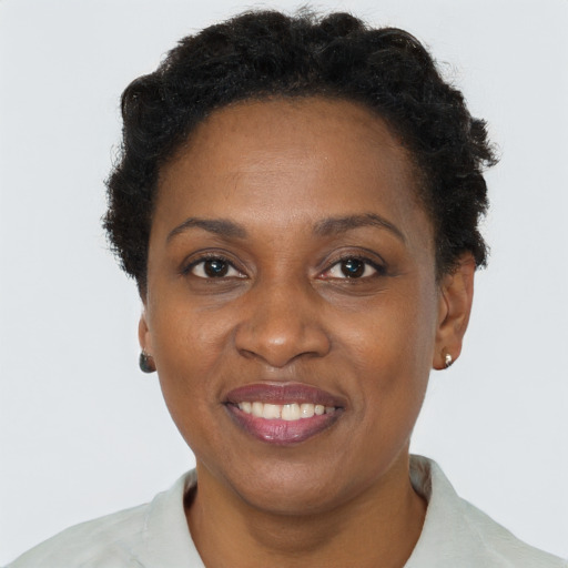 Joyful black adult female with short  brown hair and brown eyes