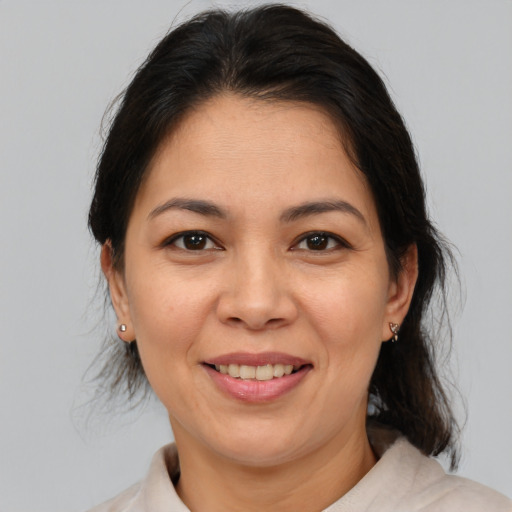 Joyful asian adult female with medium  brown hair and brown eyes