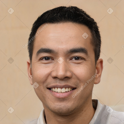 Joyful latino young-adult male with short  black hair and brown eyes