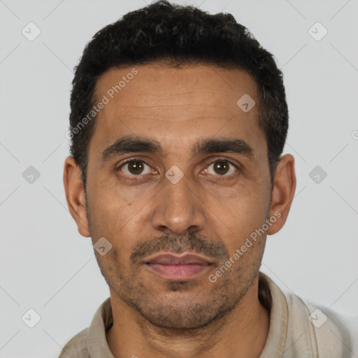 Joyful latino adult male with short  black hair and brown eyes