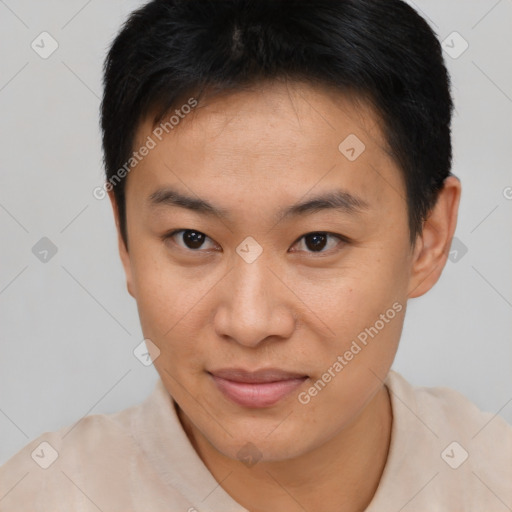Joyful asian young-adult male with short  brown hair and brown eyes