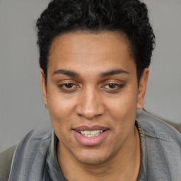 Joyful white young-adult male with short  black hair and brown eyes