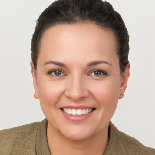 Joyful white young-adult female with short  brown hair and brown eyes