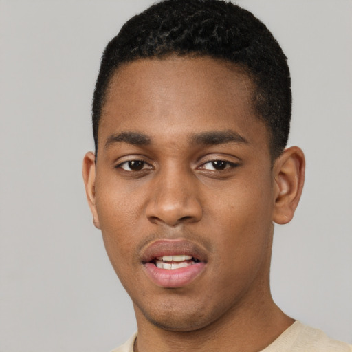 Joyful black young-adult male with short  black hair and brown eyes