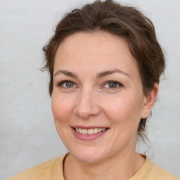 Joyful white adult female with medium  brown hair and brown eyes