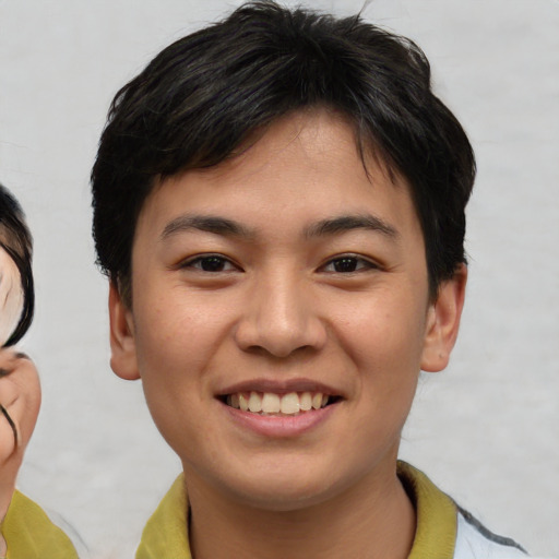 Joyful asian young-adult male with short  brown hair and brown eyes