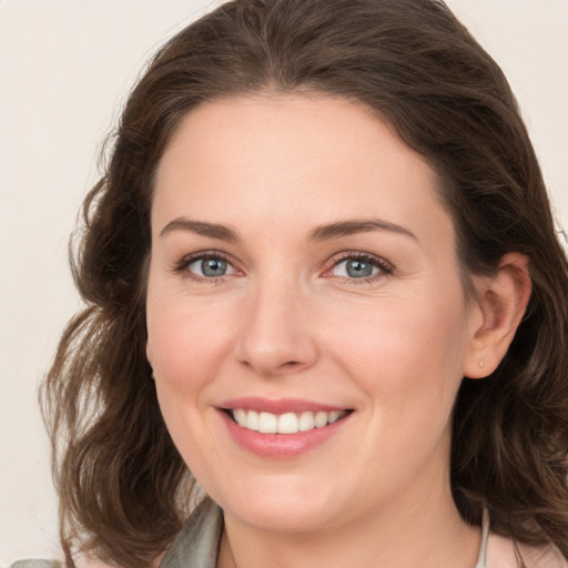 Joyful white young-adult female with medium  brown hair and green eyes