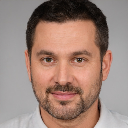 Joyful white adult male with short  brown hair and brown eyes