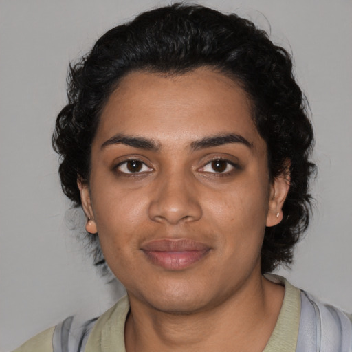 Joyful black young-adult female with medium  black hair and brown eyes