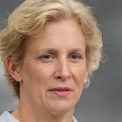 Joyful white middle-aged female with medium  brown hair and blue eyes