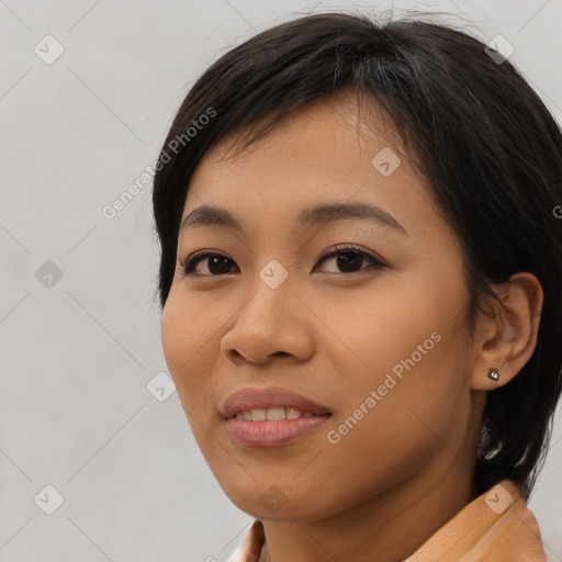 Joyful asian young-adult female with medium  brown hair and brown eyes