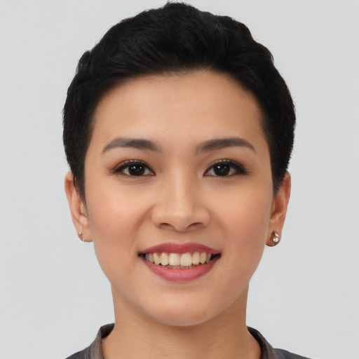 Joyful asian young-adult female with short  black hair and brown eyes