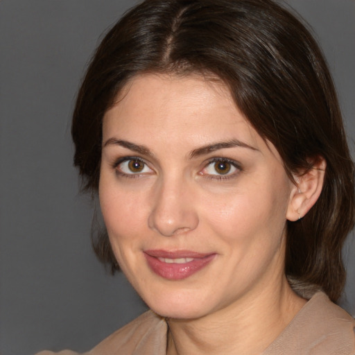 Joyful white adult female with medium  brown hair and brown eyes