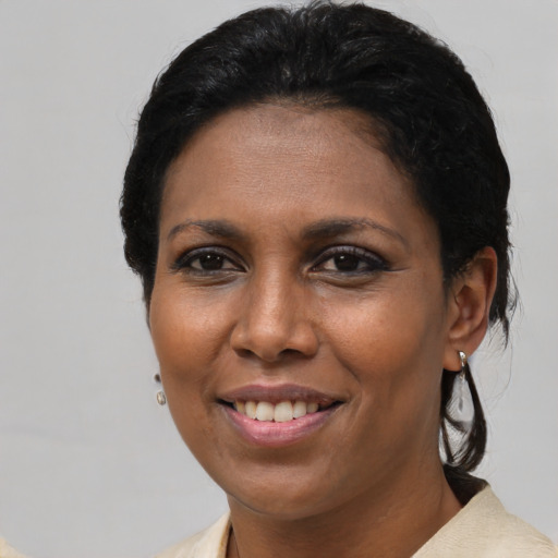 Joyful black adult female with short  brown hair and brown eyes