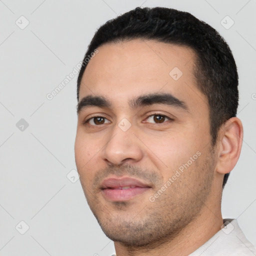 Joyful white young-adult male with short  black hair and brown eyes